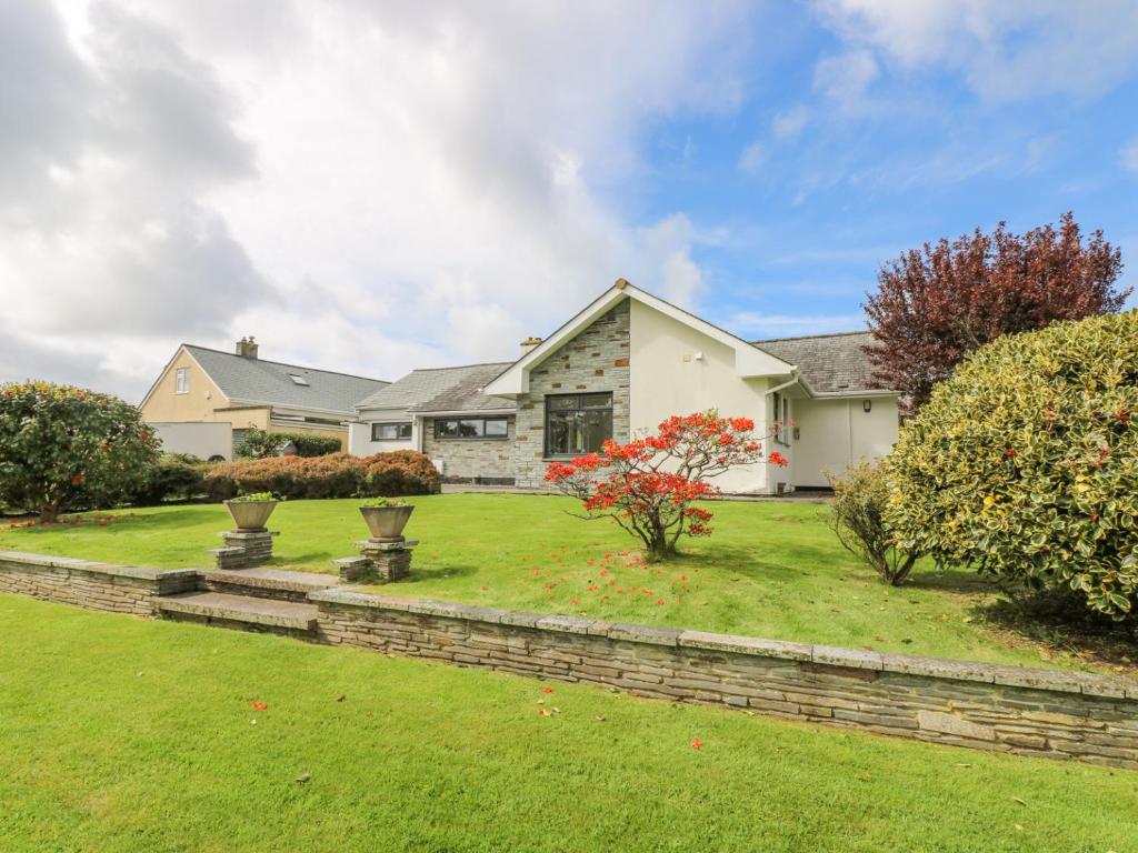 a large white house with a yard at Polkerris View in St Austell