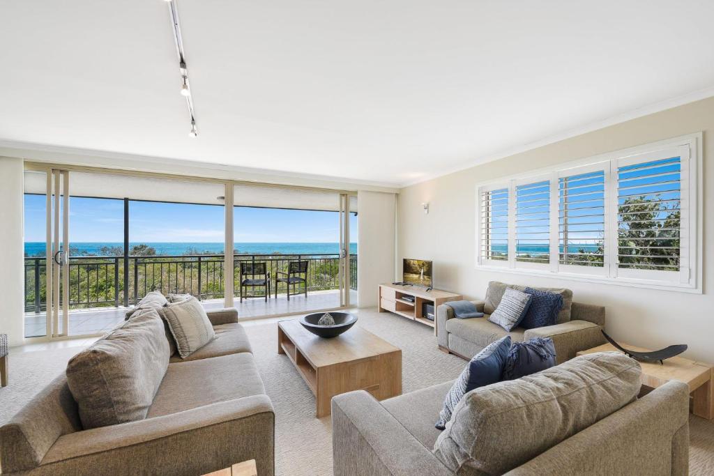 a living room with two couches and a view of the ocean at Eagles Retreat Peregian Beach in Peregian Beach
