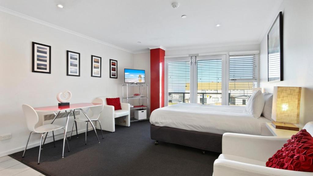 a bedroom with a bed and a table and chairs at White Crystal 112 in Mount Hotham