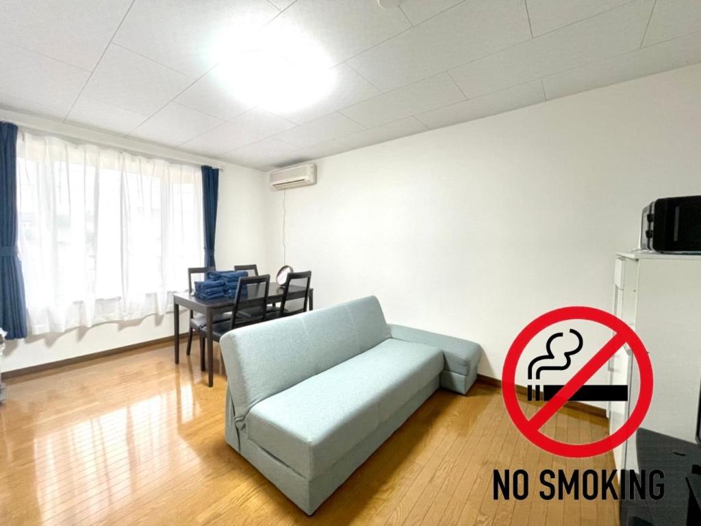 a living room with a couch and a no smoking sign at Avidasion - Vacation STAY 13342 in Biei