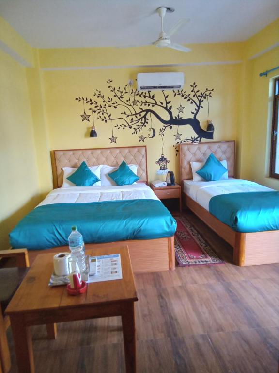 A bed or beds in a room at Hotel Mirage Sauraha