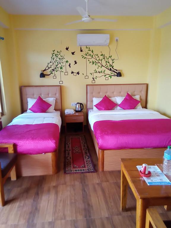 A bed or beds in a room at Hotel Mirage Sauraha