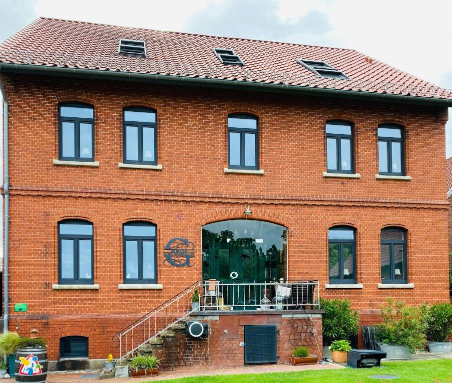 a red brick building with a large window at Pension Grunwald in Sehnde
