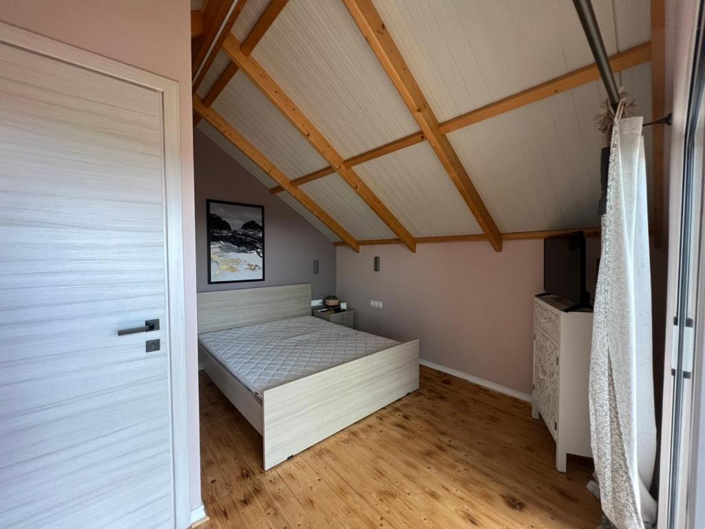 a small bedroom with a bed in a attic at Attic View in Loutsa