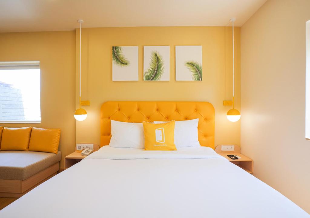 Postel nebo postele na pokoji v ubytování Bloom Hotel Koramangala