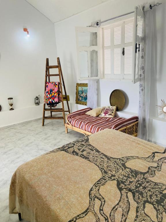 a bedroom with two beds and a chair at Dar zmen 