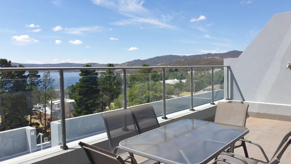 a balcony with a table and chairs and a view at The Summit 10 in Jindabyne