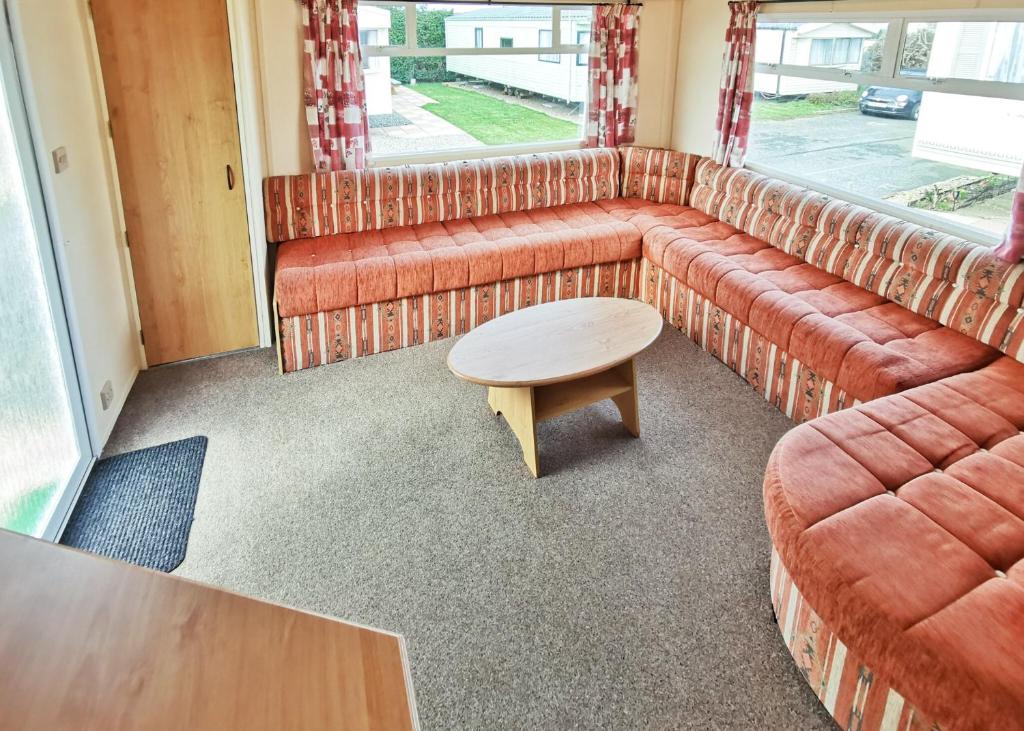 a living room with a couch and a table at Fishguard Holiday Park in Fishguard