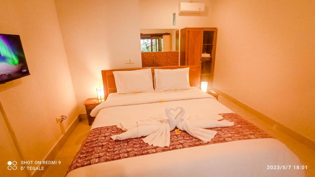 Postel nebo postele na pokoji v ubytování D' Tegal House