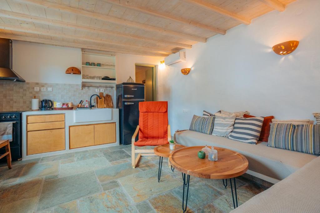 a living room with a couch and a table at Houses at Chrisopigi Sifnos in Chrisopigi