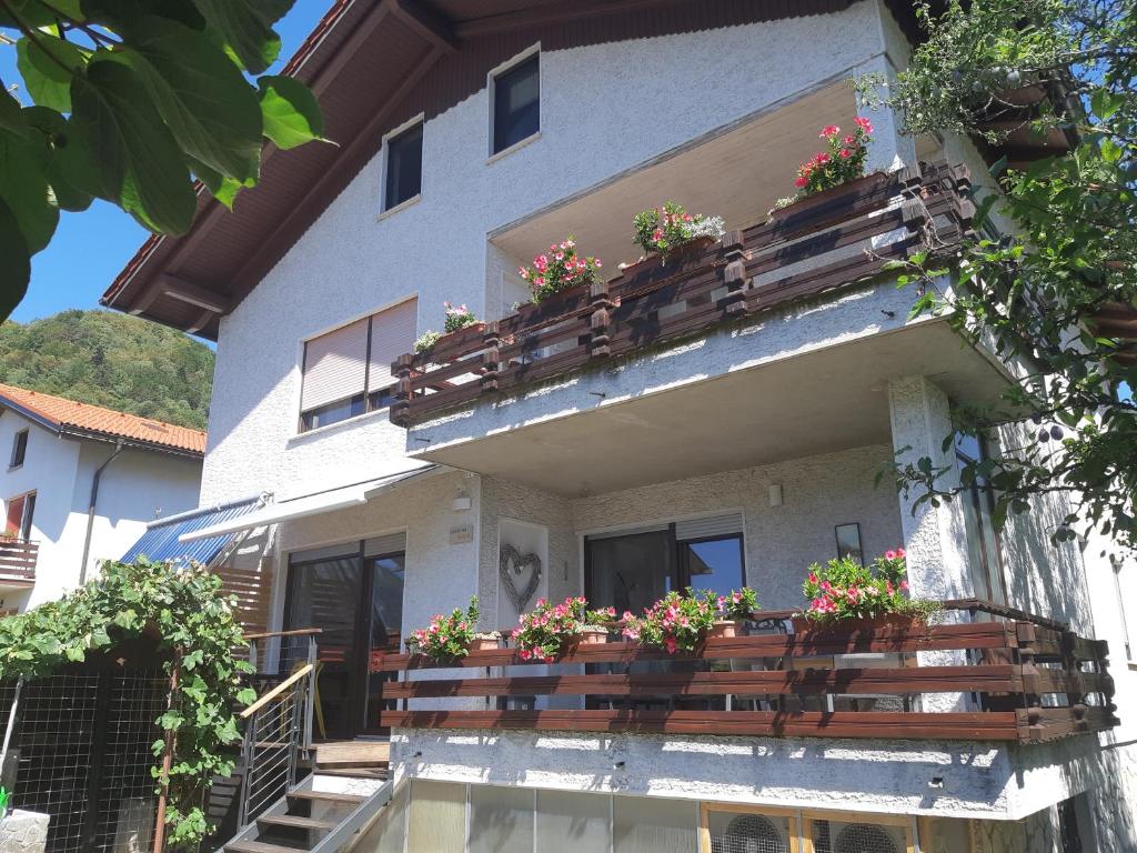 a building with flower boxes on the balcony at Apartma BoLeRo in Tolmin