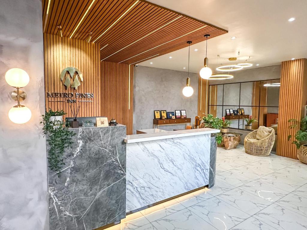 a lobby with a counter and a reception desk at Metro Pines Inn in Baguio