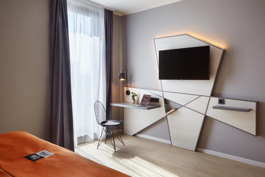 TV a/nebo společenská místnost v ubytování Holiday Inn - the niu, Hub Dusseldorf Messe by IHG