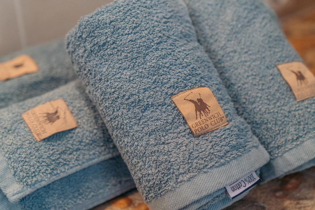 a pile of blue towels with tags on them at Houses at Chrisopigi Sifnos in Chrisopigi