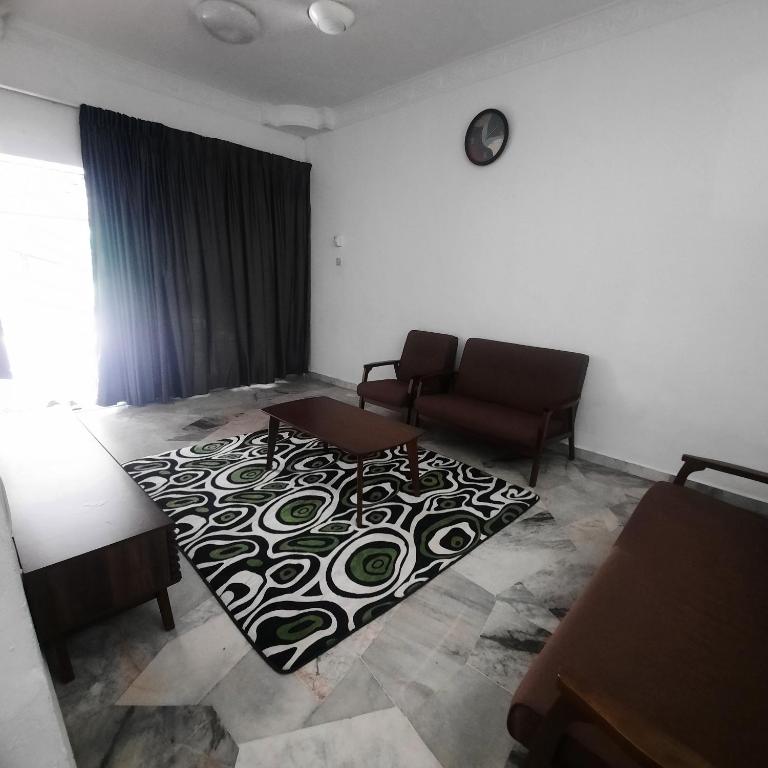 a living room with a couch and a rug at Homestay Sunnah Seri Manjung Islam in Seri Manjung