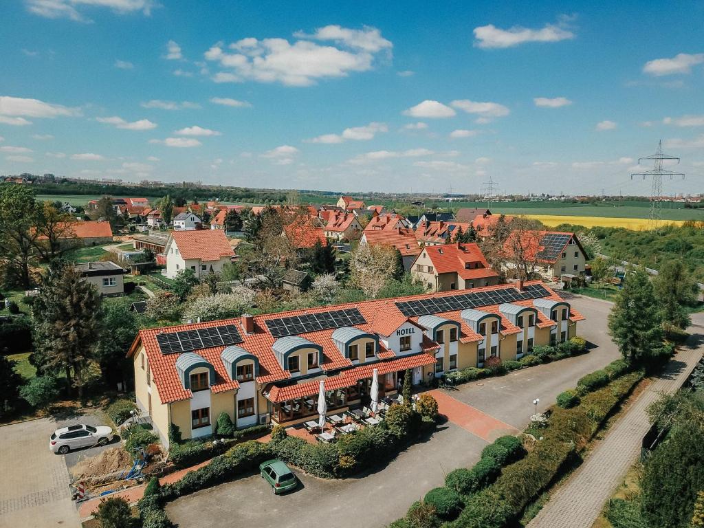 an aerial view of a house with solar panels on its roofs at Landhotel Dresden in Dresden