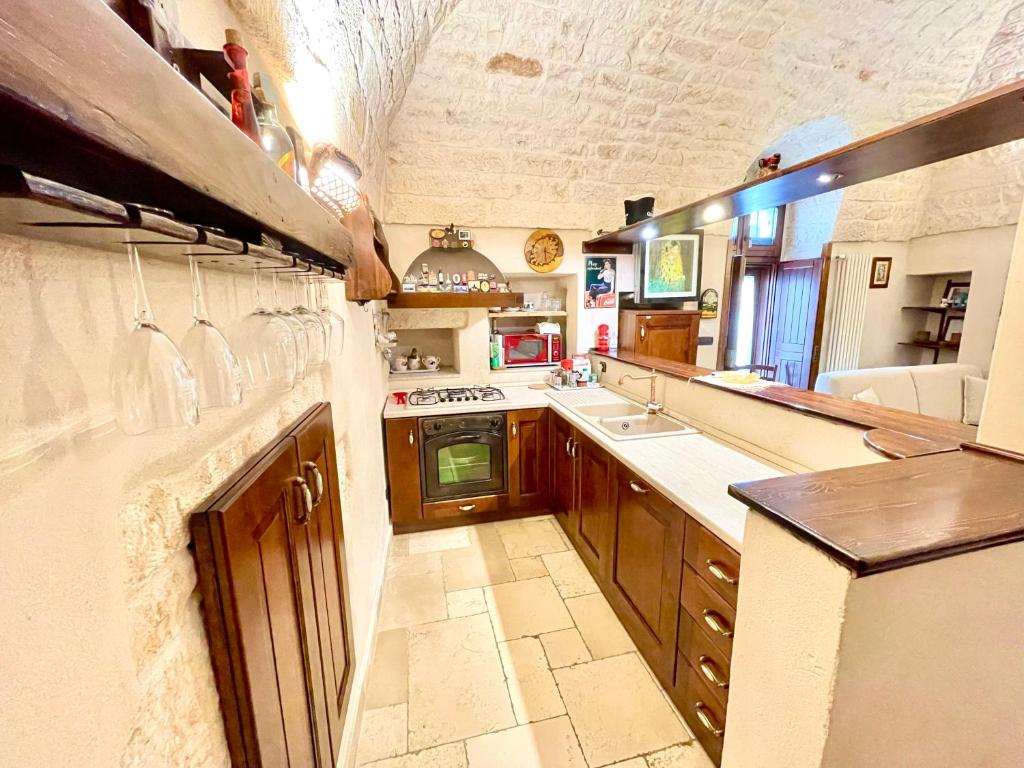 a large kitchen with a sink and a stove at Casa Vega in Ostuni