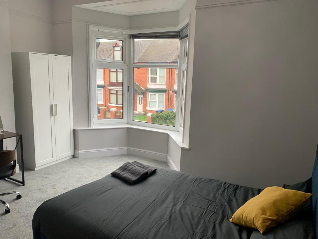 a bedroom with a bed and a window at Ayresome House in Middlesbrough