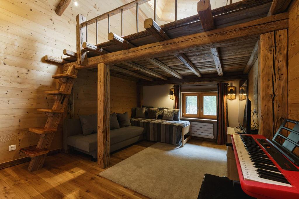 a living room with a loft bed and a piano at Chalet Mollard - Happy Rentals in Vallorcine