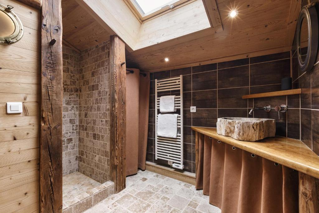 a bathroom with a stone sink and a window at Chalet Mollard - Happy Rentals in Vallorcine