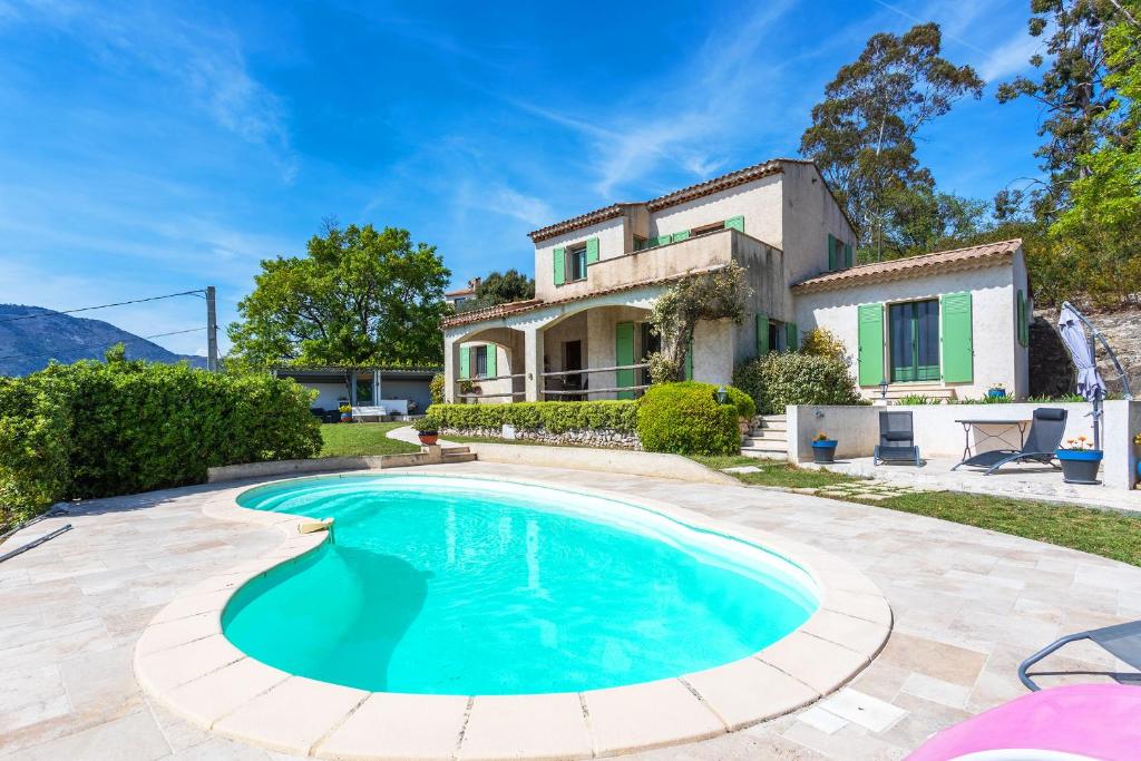 a villa with a swimming pool in front of a house at VILLA ROCHE GRISE - Berre-les-Alpes in Berre-des-Alpes