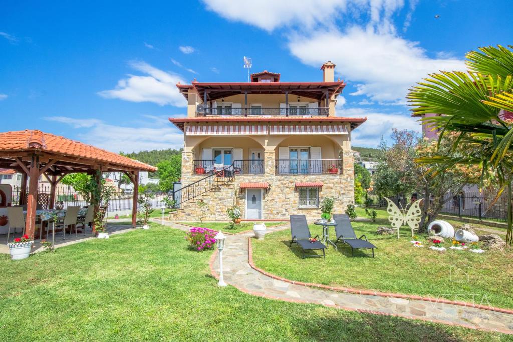 a large house with a garden and a gazebo at Private 6-bdrm Villa with garden 150m to beach in Paradisos