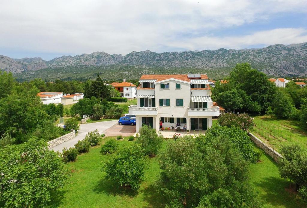 an aerial view of a house with mountains in the background at Apartments Vila Ana in Seline
