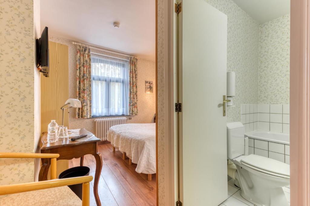 Postel nebo postele na pokoji v ubytování Hôtel Le Cor de Chasse