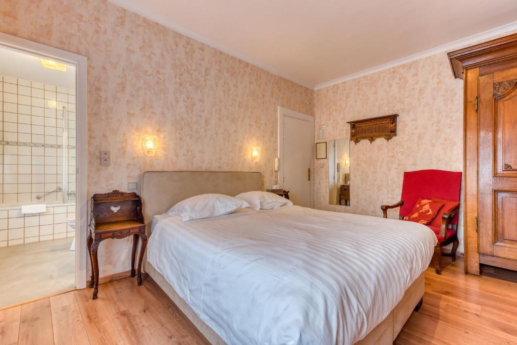 Postel nebo postele na pokoji v ubytování Hôtel Le Cor de Chasse