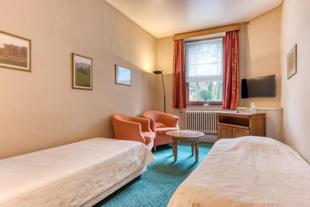 Postel nebo postele na pokoji v ubytování Hôtel Le Cor de Chasse