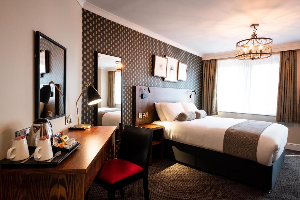 a hotel room with a bed and a desk at Miller & Carter Sheffield by Innkeeper's Collection in Sheffield