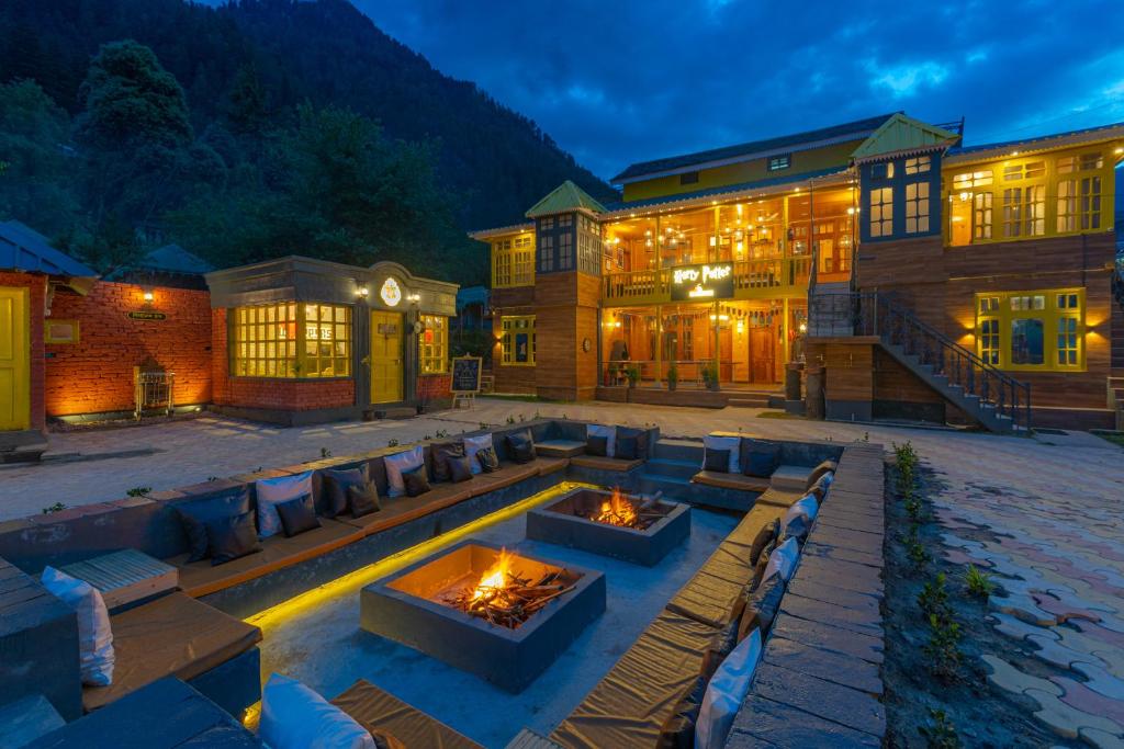 a patio with a fire pit in front of a building at Whoopers Boutique Kasol in Kasol