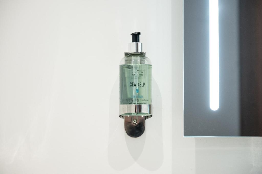a green bottle is hanging on a wall at Miller & Carter Sheffield by Innkeeper's Collection in Sheffield