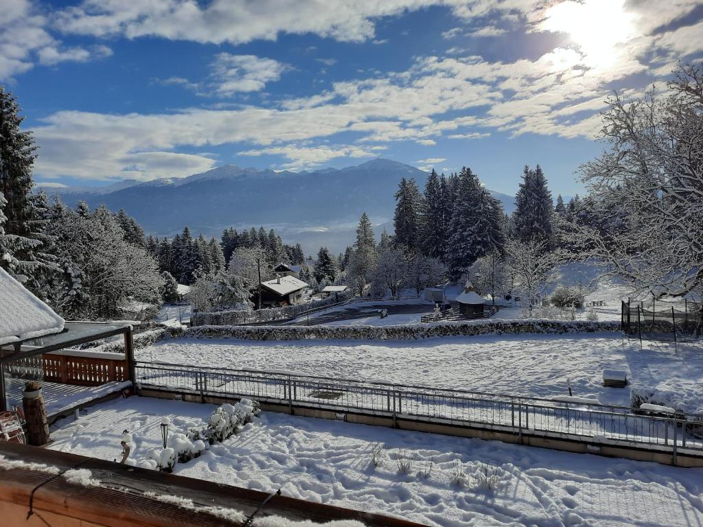 a snow covered field with mountains in the background at Sweet Cherry - Boutique &amp; Guesthouse Tyrol in Innsbruck