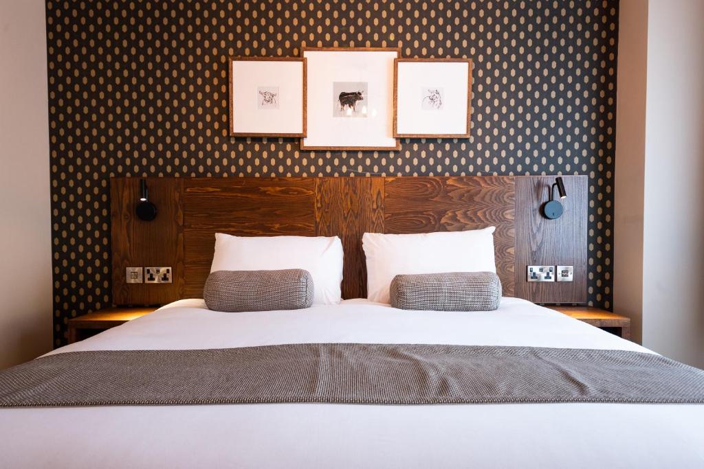 a bedroom with a large bed with two pillows at Miller & Carter Sheffield by Innkeeper's Collection in Sheffield