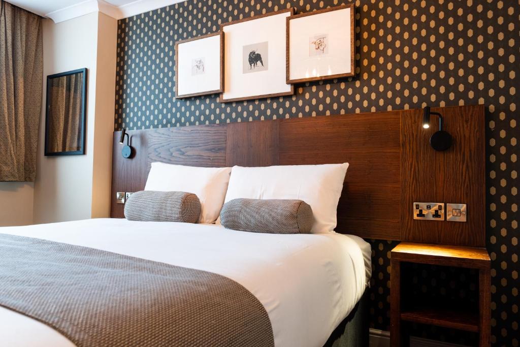 a hotel room with a bed and pictures on the wall at Miller & Carter Sheffield by Innkeeper's Collection in Sheffield