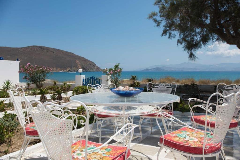 a table and chairs with a view of the ocean at Lovely House Infront Of The Beach In Molos in Molos Parou