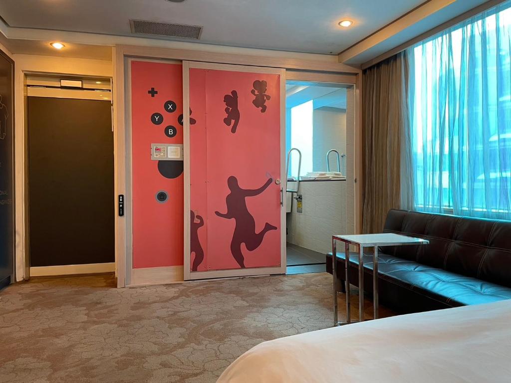 a hotel room with a sliding door with a couch and a room at Yomi Hotel - ShuangLian MRT in Taipei