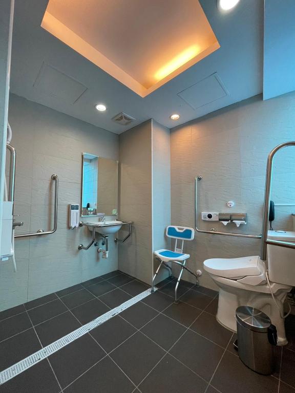 a bathroom with a toilet and a sink at Yomi Hotel - ShuangLian MRT in Taipei