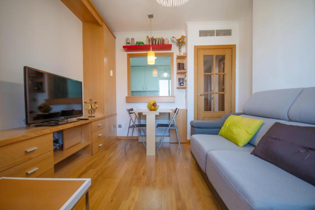 a living room with a couch and a tv and a table at For Your Rentals Cómodo y tranquilo apartamento Aeropuerto CMP9 in Madrid