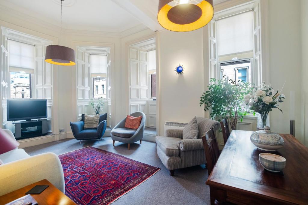 a living room with a couch and a table at West George Street Apartment in Glasgow