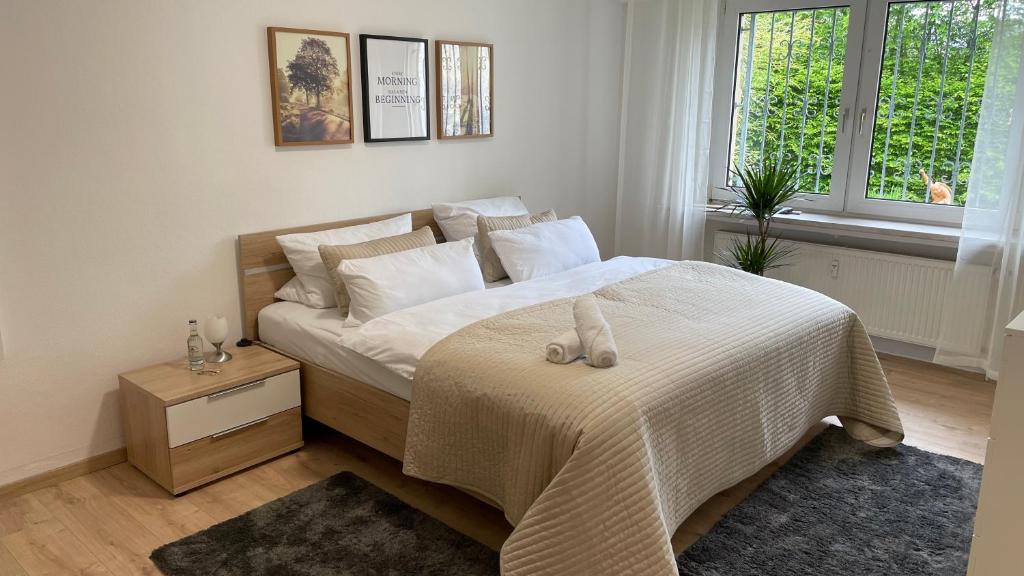 a bedroom with a bed with white sheets and a window at Modern Terrace Apartment Free Wifi Free Parking and Netflix in Hamm