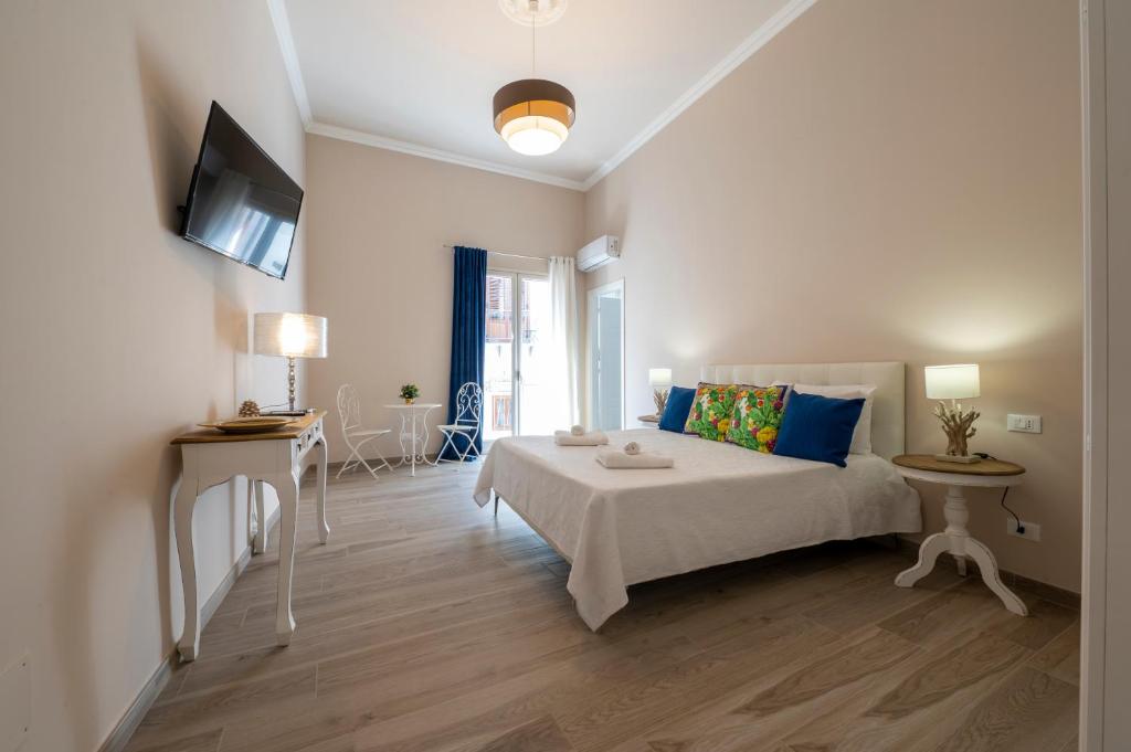 a bedroom with a bed and a television in it at Domus Federiciana in Castellammare del Golfo
