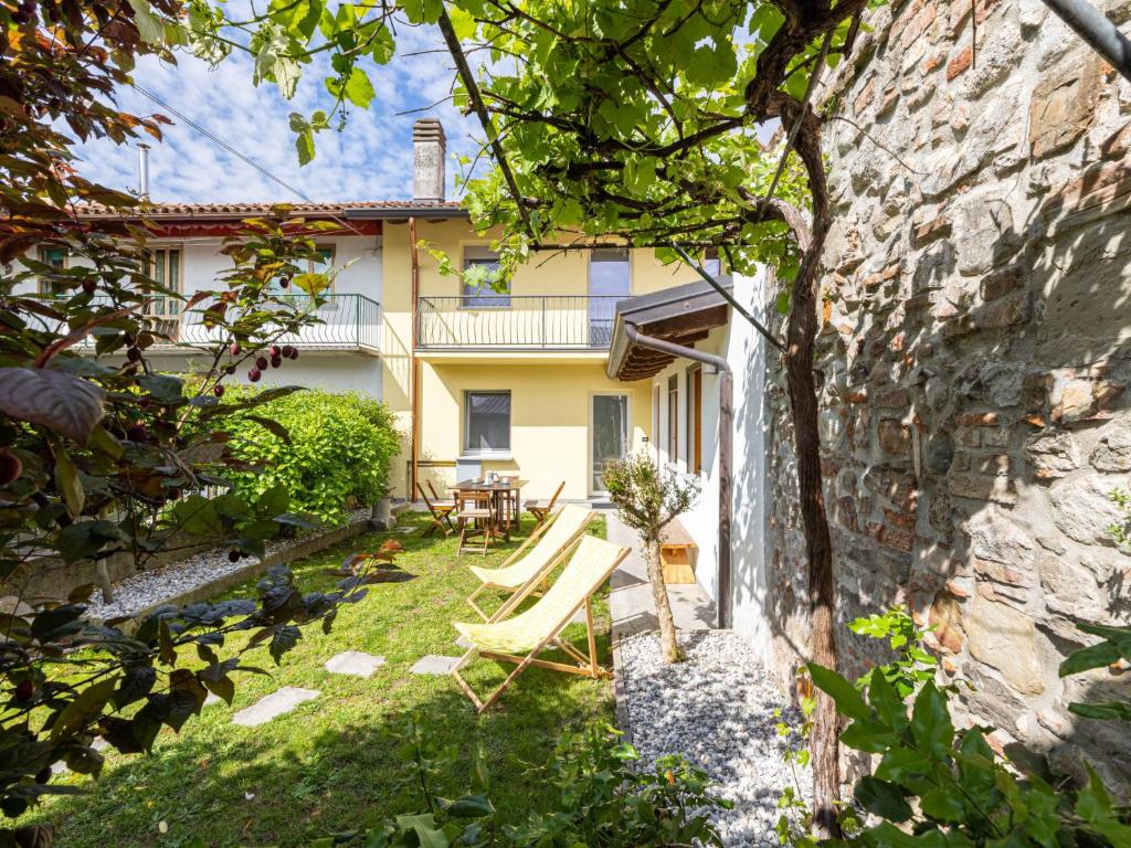 a garden with a table and chairs in front of a building at Holiday Home Le Mura by Interhome in Cividale del Friuli