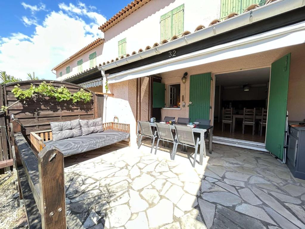 a patio with a couch and a table at Mazet rénové à Ste-Maxime, 3 pièces, 6 couchages, centre-ville, plage à 500m - FR-1-226-517 in Sainte-Maxime