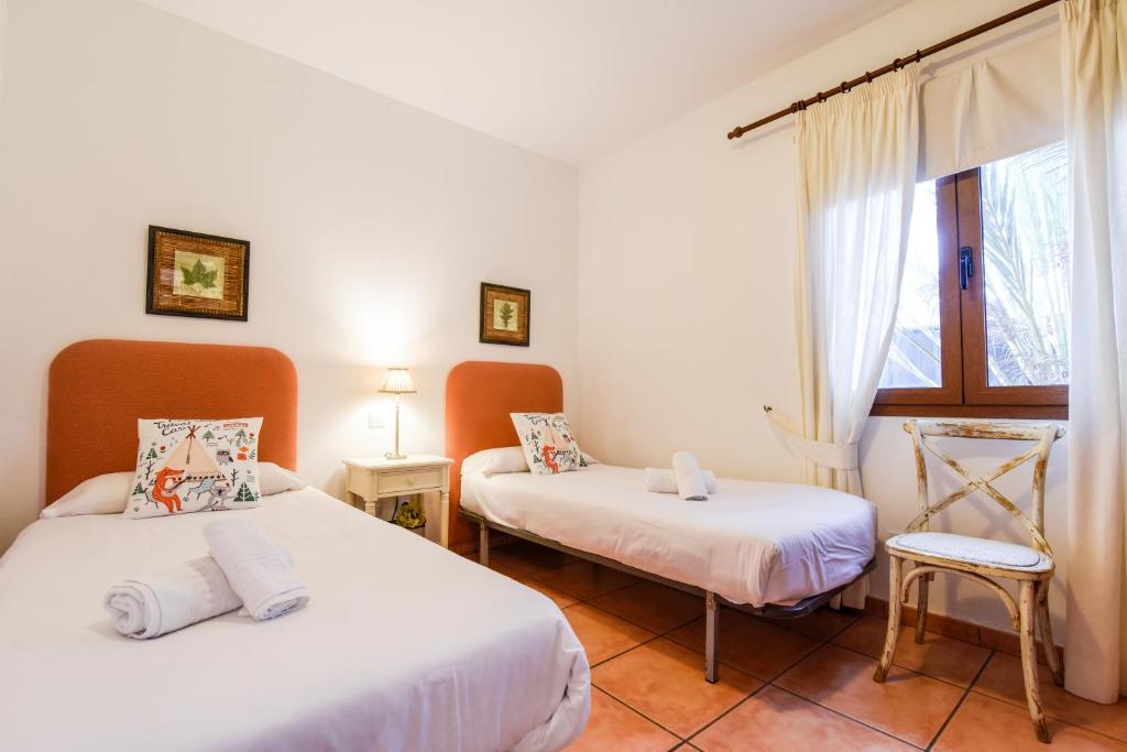 a room with two beds and a window at Ereza Villa Paraiso in La Oliva