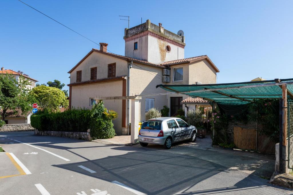 a car parked in a parking lot in front of a house at House Domenico in Rovinj