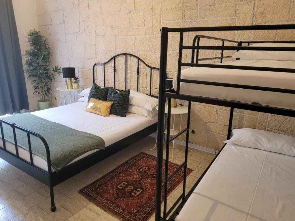 a bedroom with two bunk beds and a rug at Ambra Boutique Hotel in Milan