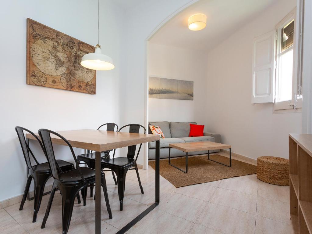 a dining room with a table and chairs and a couch at Centric Sagrada Familia Apartments in Barcelona