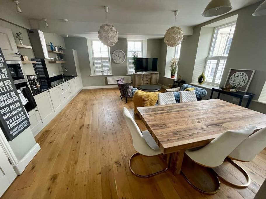 a living room with a wooden table and chairs at Luxurious 2 bedroom apartment in central Berwick in Berwick-Upon-Tweed